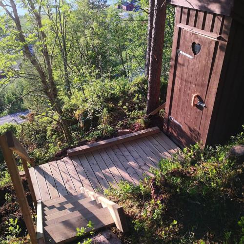a wooden porch with a door and a bench at Sørfjorden Eye Iglo - Fosen in Husby