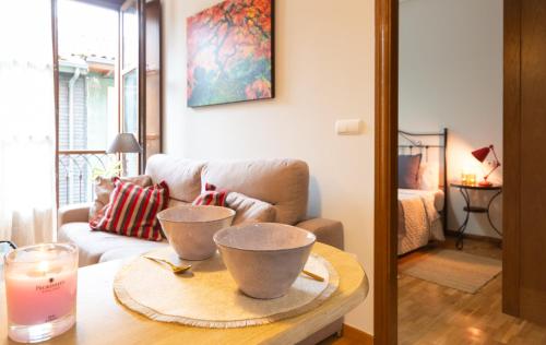 a living room with a table with two bowls on it at Apartamento Las Cruces 3 in Gijón