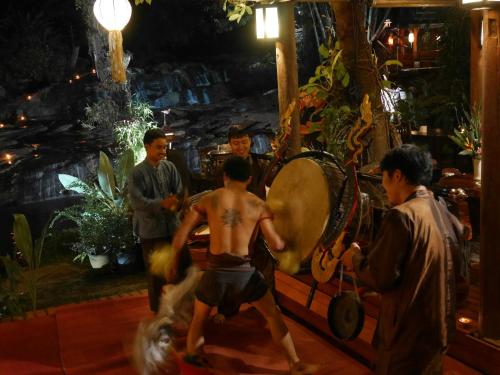a man with a tattoo on his back playing a game at Sukantara Cascade Resort and Spa in Mae Rim