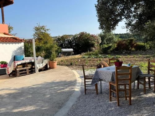 a table and chairs with a table and a table and a table and a table at Anemomilos in Samos