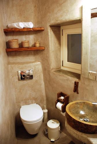 a bathroom with a toilet and a sink at The Weaver's house in Kithnos