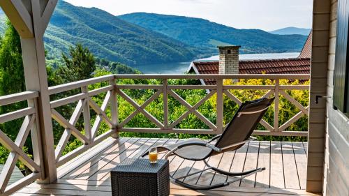 a chair on a deck with a view of a mountain at Jutrzenka in Międzybrodzie Kobiernickie