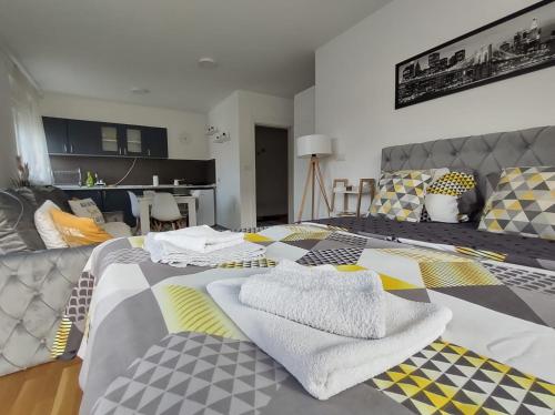 a bedroom with a bed with towels on it at Apartman Natura in Vrnjačka Banja