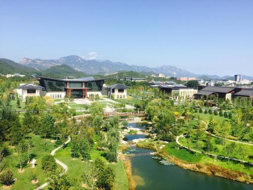 an aerial view of a resort with a river at Yanqi Hotel, Managed by Kempinski in Huairou