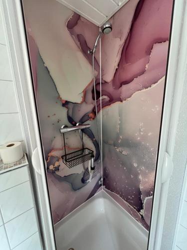 a shower in a bathroom with a damaged ceiling at Pension Lachmann in Pfaffendorf