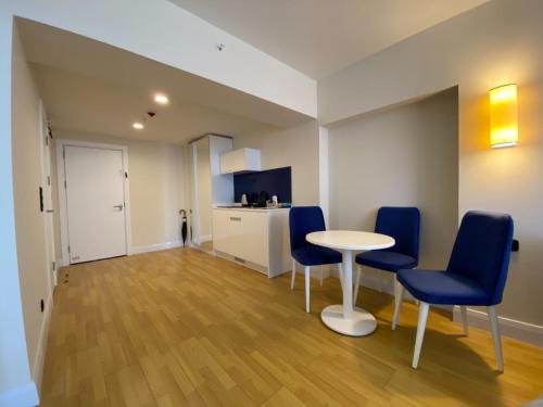 a room with a table and chairs and a kitchen at Batumi Aparthotel In Orbi City 2025 in Batumi