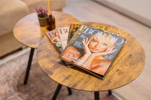 a wooden table with magazines on top of it at Keis Apartments in Tirana
