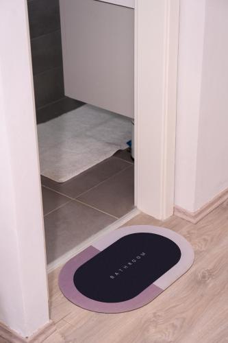 a black and purple rug on the floor in front of a door at Keis Apartments in Tirana