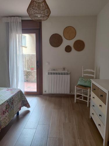 a bedroom with a bed and two mirrors on the wall at El granero de Mara in Jaca