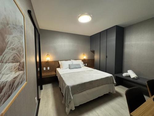 a bedroom with a large bed in a room at Flat Crystal Place 209 in Goiânia
