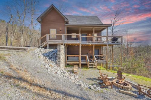 a house on a hill with chairs in front of it at Wild Heart Lodge cabin in Sevierville