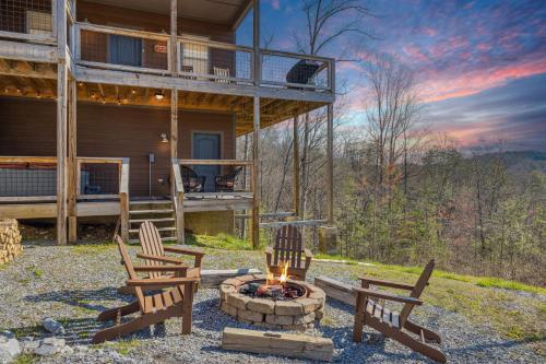 a group of chairs sitting around a fire pit in front of a house at Wild Heart Lodge cabin in Sevierville
