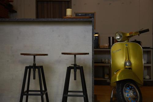 a yellow scooter parked next to two bar stools at 日月潭 3JD home 一館 in Yuchi