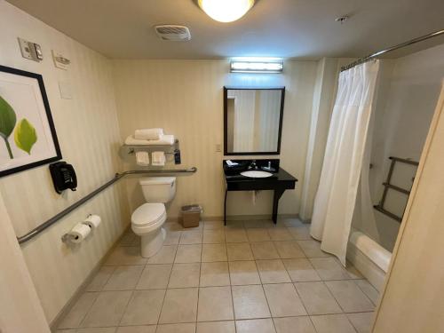 a bathroom with a toilet and a sink at Fairfield by Marriott Inn & Suites Melbourne West/Palm Bay in Melbourne