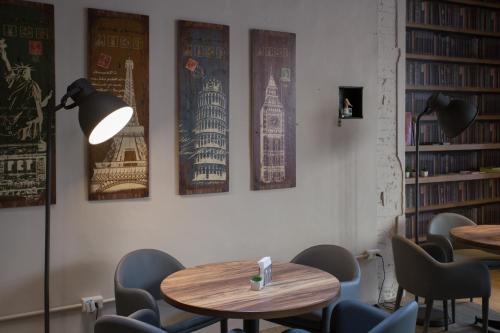 a room with tables and chairs and posters on the wall at 日月潭 3JD home 一館 in Yuchi