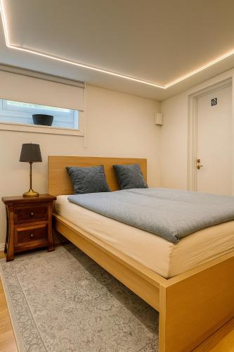 a bedroom with a large bed and a window at Röd Stuga by Falunio in Södertälje