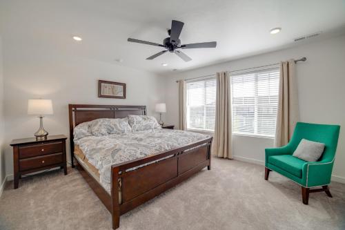 a bedroom with a bed and a green chair at Pool, Park and Peace Skyview Landing in Eagle! in Eagle