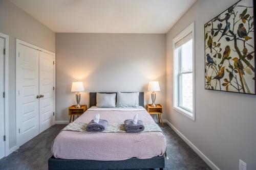 a bedroom with a bed with two towels on it at Modern & Spacious 3bd 3ba RoofDeck in Washington