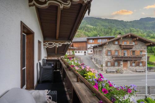 a balcony of a building with flowers on it at Ferienwohnung Holzegger in Hart im Zillertal