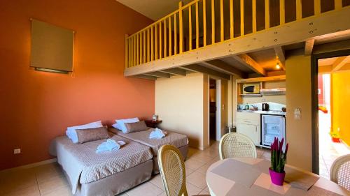 a living room with two beds and a staircase at Crystal Palace - Vista in Skala Kefalonias