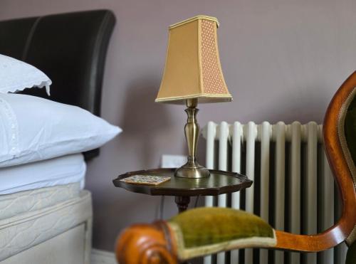 a lamp on a side table next to a radiator at The Steam Packet in Littlehampton