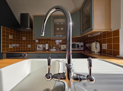 a kitchen sink with a faucet in a kitchen at The Steam Packet in Littlehampton