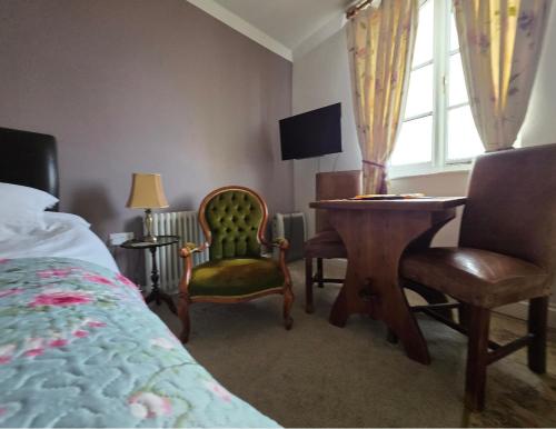 a bedroom with a bed and a table and chairs at The Steam Packet in Littlehampton