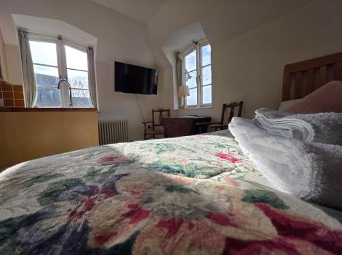 a bedroom with a bed with a colorful blanket on it at The Steam Packet in Littlehampton