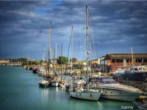 a group of boats docked in a harbor at The Steam Packet in Littlehampton