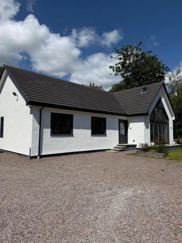 a white house with a black roof at Gili Taigh in Fort William
