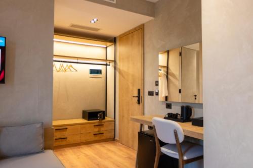 a small kitchen with a counter and a table at Montis Agroturizëm Hotel Spa in Kaninë