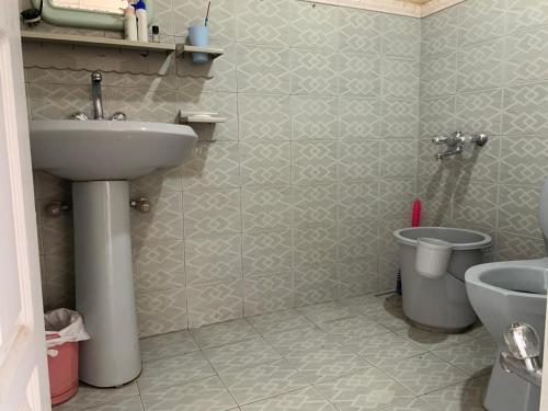 a bathroom with a sink and a toilet at Private Retreat in Muzaffarabad