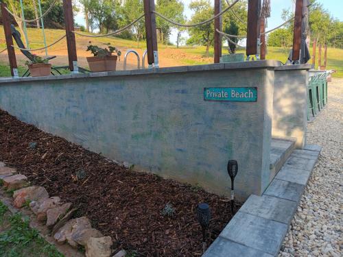 a concrete wall with a sign that reads trade beach at Villa Evetes in Jablonov nad Turnou