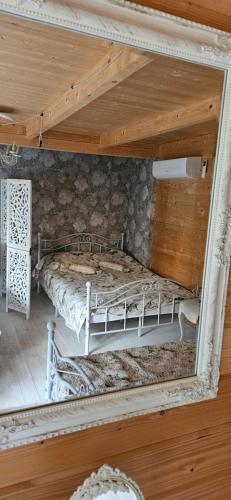 an old bed in a room with a mirror at Vila Skodupė 