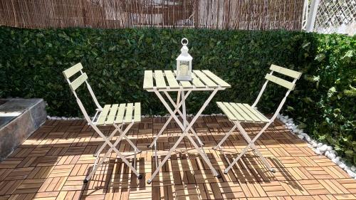 two chairs and a table with a lantern on it at Bungalow en Santa Pola in Santa Pola