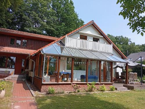a house with large glass doors and a balcony at Homeland in Niederdorla