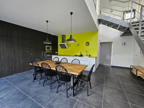 une cuisine et une salle à manger avec une table et des chaises en bois dans l'établissement Maison d'architecte 9p - 400m de la mer & du bourg, à Santec