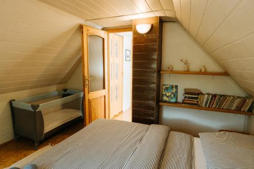 a attic room with a bed and a window at Chata Barborka in Terchová