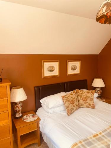 a bedroom with a bed with two lamps on a table at The Steam Packet in Littlehampton