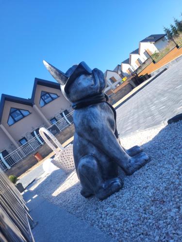 a statue of a bear sitting next to a chair at Sun Paradise in Rewal