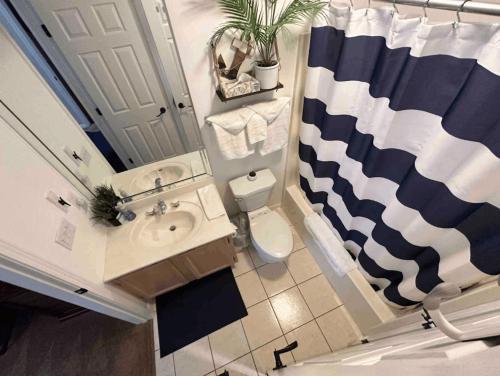 een badkamer met een wastafel, een toilet en een spiegel bij Lakeview Lake Ozark Condo 2bd2bapool-sleeps 7pp in Lake Ozark