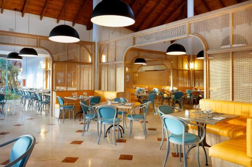 a restaurant with tables and chairs in a room at Grand Palladium Punta Cana Resort & Spa - All Inclusive in Punta Cana