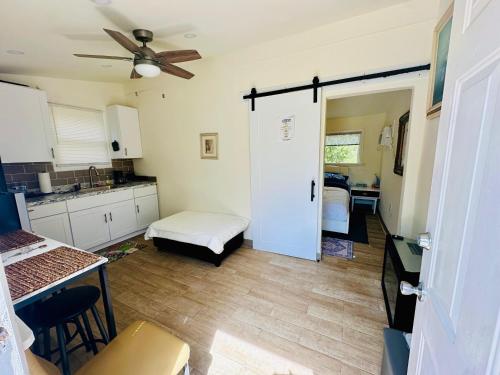 a kitchen with a door leading to a bedroom at Tiny House With Private Pool in Glen Burnie