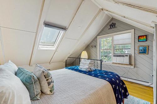 a bedroom with a bed in a room with a window at Monument View in Provincetown