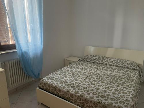 a small bedroom with a bed and a window at cozy house in Olgiate Comasco in Olgiate Comasco
