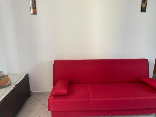 a red couch sitting in a living room at cozy house in Olgiate Comasco in Olgiate Comasco