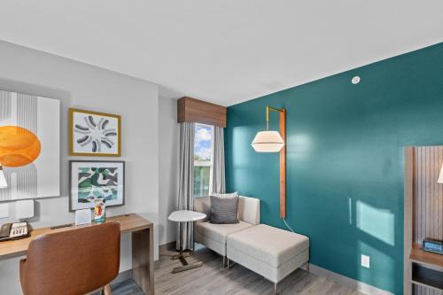 a living room with a desk and a chair at Holiday Inn Hotel & Suites Surrey East - Cloverdale by IHG in Surrey