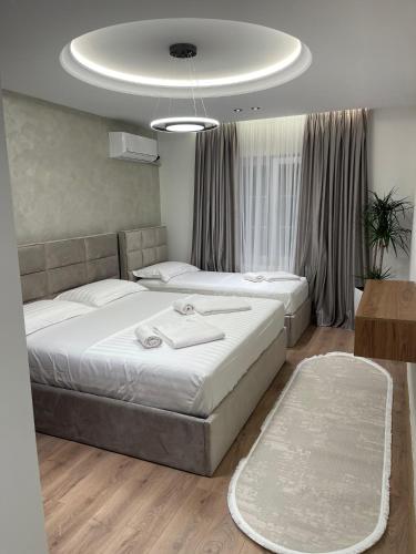 a bedroom with two beds and a table at Stone Bazaar Villa in Krujë