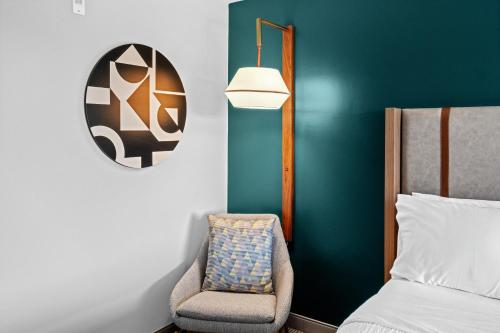 a bedroom with a bed and a chair at Holiday Inn Hotel & Suites Surrey East - Cloverdale by IHG in Surrey