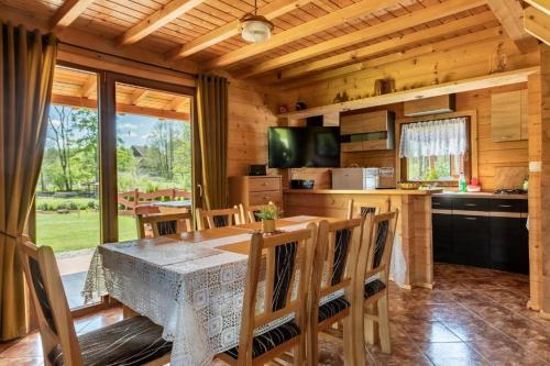 a kitchen and dining room with a table and chairs at Żuraw in Wyszowate